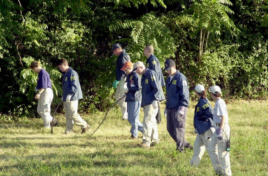 FBI agents search the grounds surrounding the Pentagon on September 12, 2001 in Arlington, Virginia for any evidence related to the attack.(Photo: UPI Photo Service/Michael Kleinfeld/Newscom)