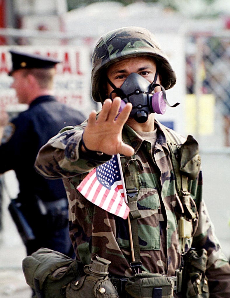 A National Guardsman directs pedestrian traffic near the World Trade Center terrorist attack site in New York, September 19, 2001. (Photo: UPI Photo Service/Roger L. Wollenberg/Newscom)