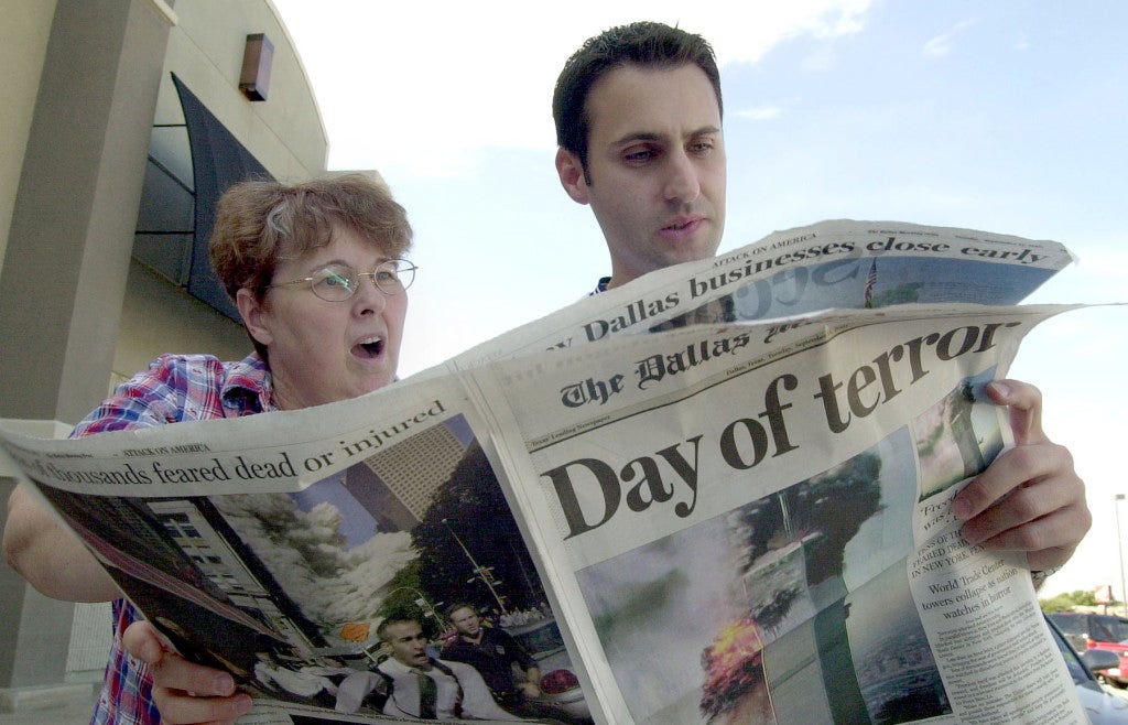 Jeanie Quest and Phillip Jabour read a special edition of the Dallas Morning News in Dallas, Texas September 11, 2001. (Photo: UPI Photo Service/Ian Halperin/Newscom)