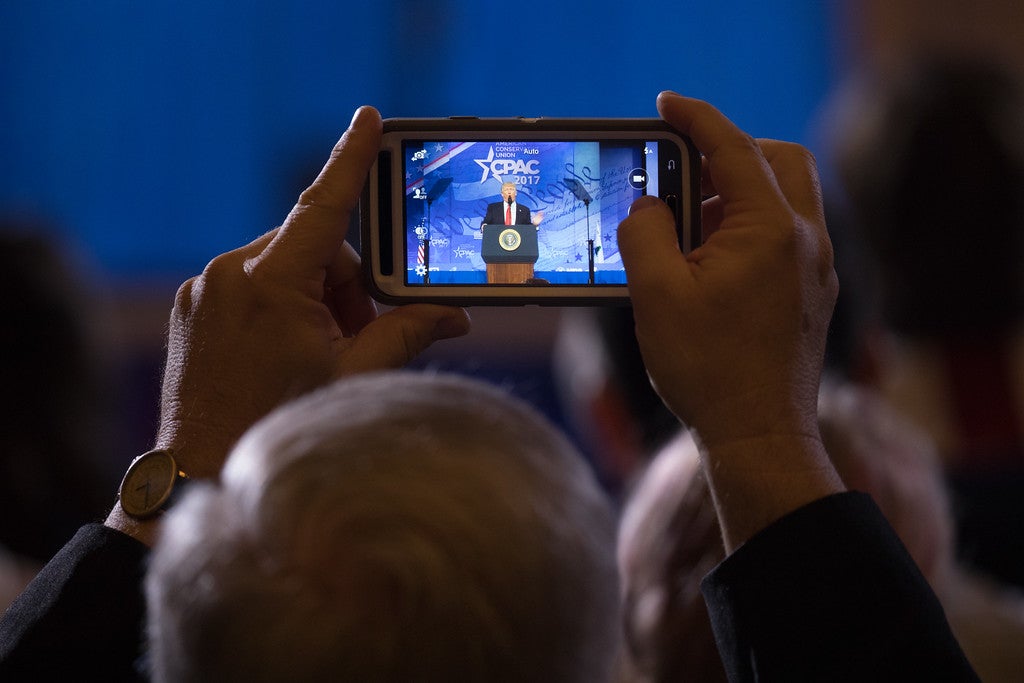A CPAC attendee captures a presidential moment. (Photo: Jeff Malet for The Daily Signal)