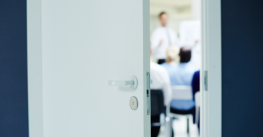 kids in class behind half-open door