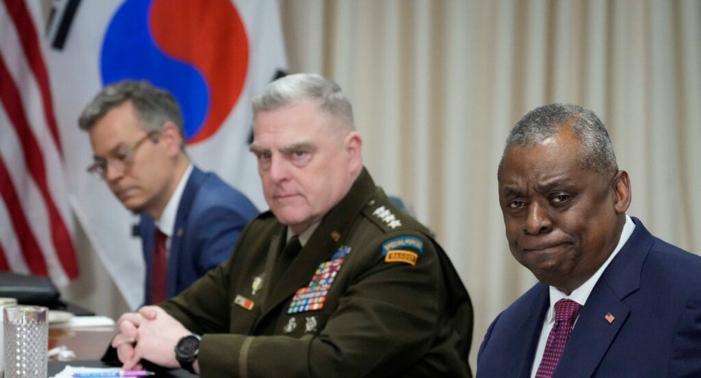 Mark Milley in uniform sits next to Lloyd Austin in a suit