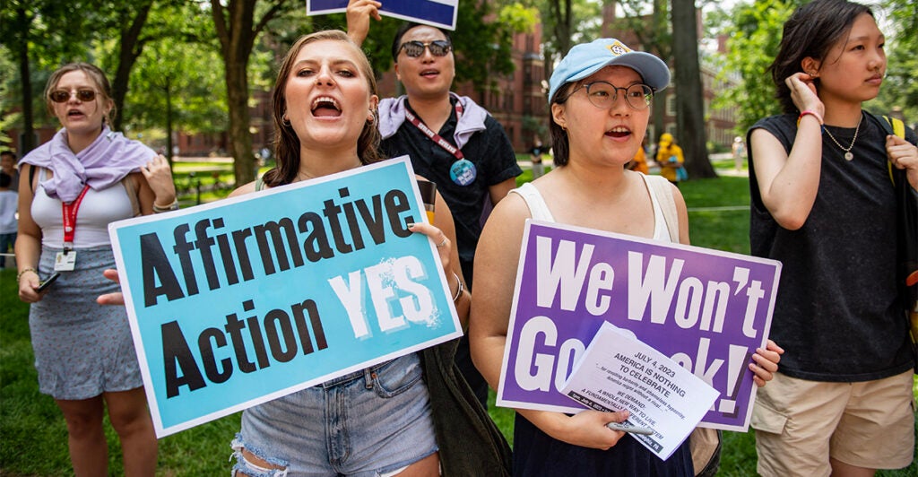 Students hold signs protesting for affirmative action