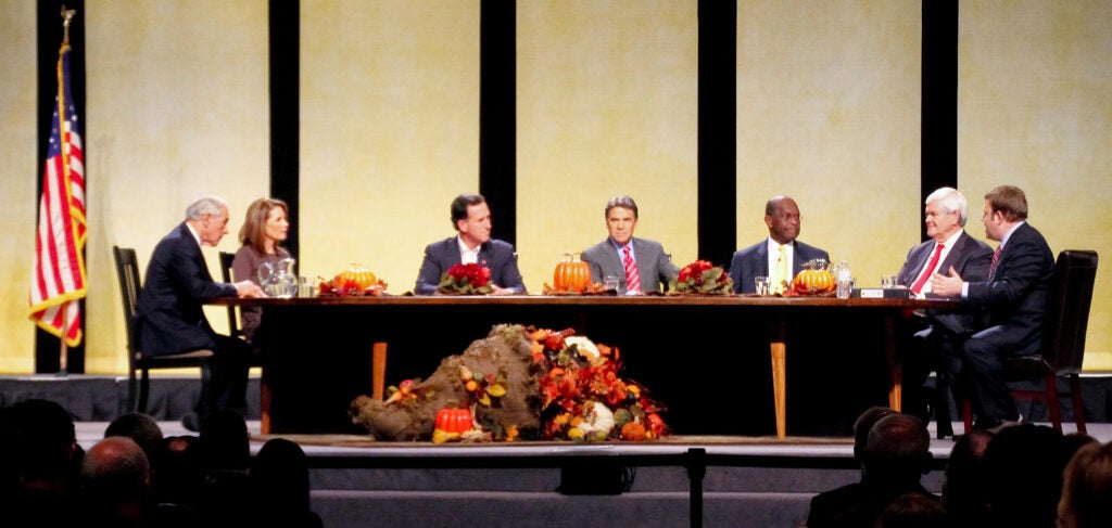 Ron Paul, Michele Bachmann, Rick Santorum, Rick Perry, Herman Cain, Newt Gingrich, and Bob Vander Plaats around a table
