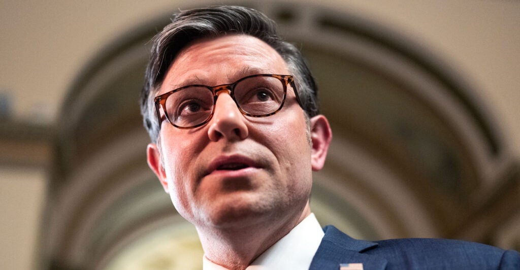 Headshot of House Speaker Mike Johnson looking up toward the ceiling of a Capitol building hallway