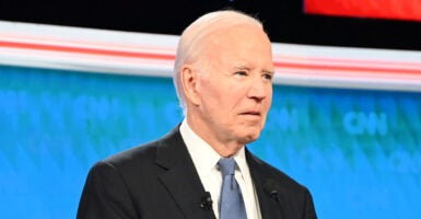 Joe Biden in a suit looks blankly in the debate