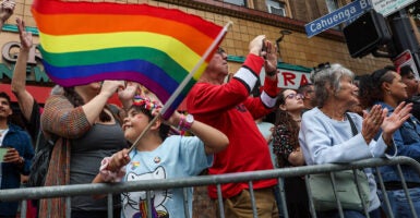 A child waves a rainbow flag at a gay pride parade during the month of June in Los Angeles.