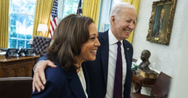 Kamala Harris and Joe Biden smile in the Oval Office