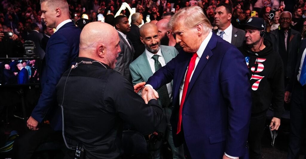 Podcaster Joe Rogan shakes the hand of President-elect Donald Trump at a UFC fight.