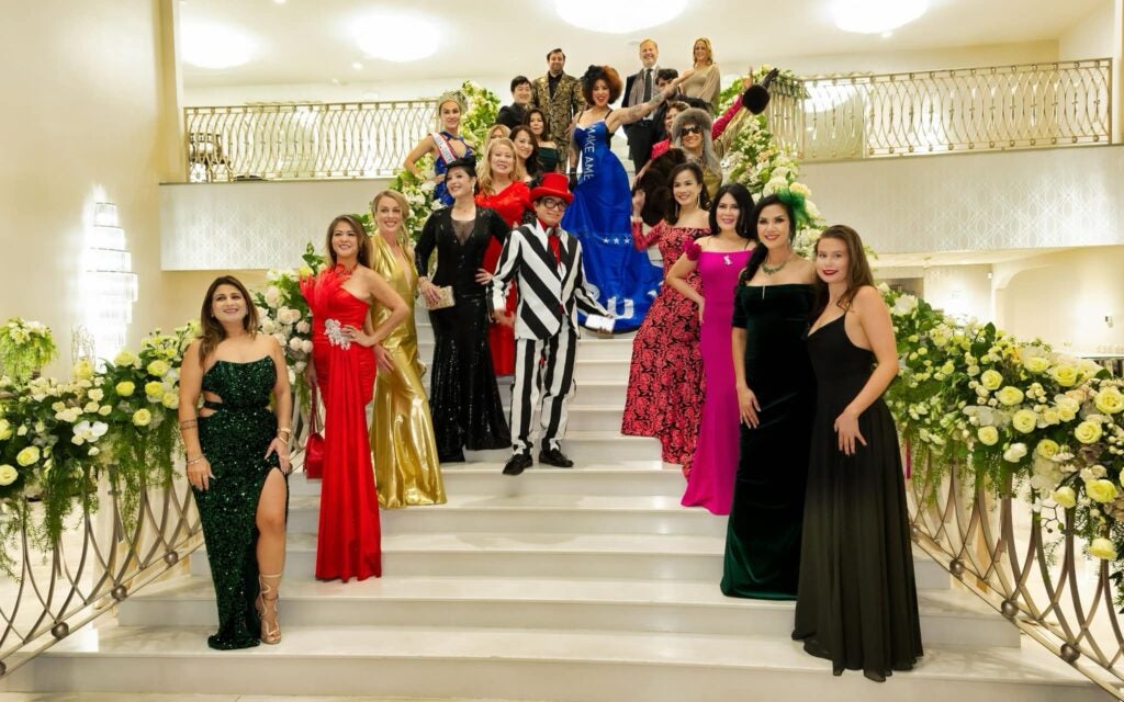 Fashion designer Andre Soriano, in a black-and-white-striped outfit and a bevy of models in his first ladies dresses collection on a stairwell