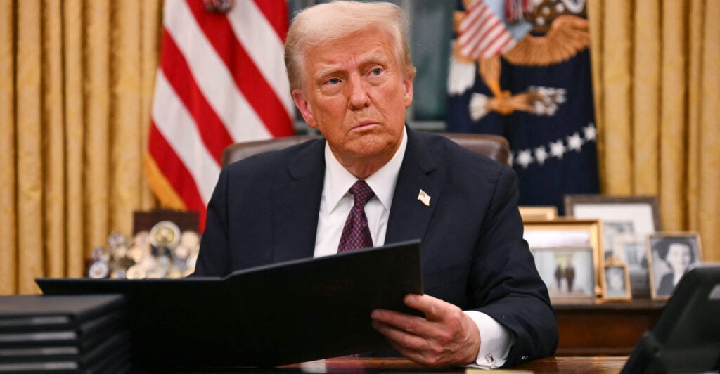 President Donald Trump signs an executive order for pardons of Jan. 6 offenders in the Oval Office on Jan. 20.