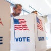 Voters marking their ballots at the polls
