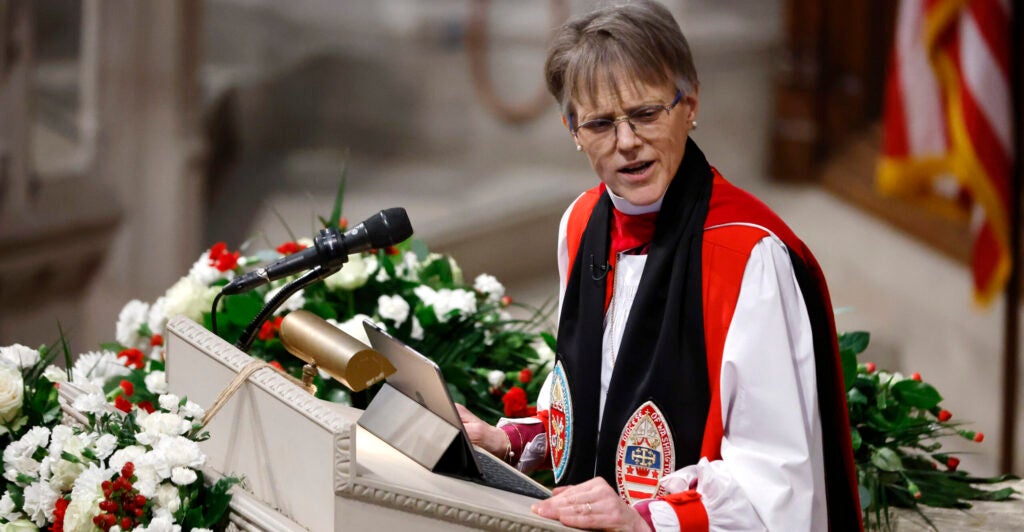 Episcopal Bishop Mariann Edgar Budde in clerical garb at the pulpit