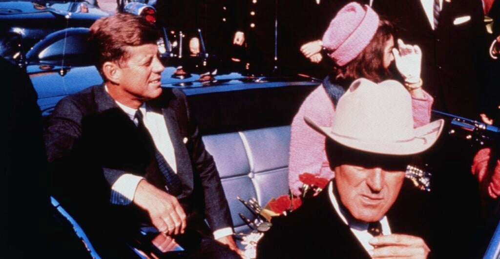 President John F. Kennedy sits in the back seat of a car on the day he was assassinated.