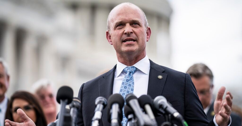 Kevin Roberts, president of Heritage Action for America, stands before microphones as he speaks.