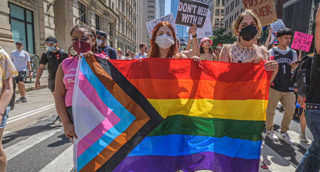 Woman holds LGBTQ flag