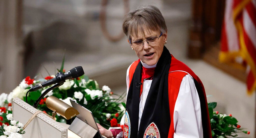Episcopal Bishop Mariann Budde in red and black robes scowls