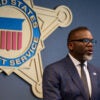 Chicago Mayor Brandon Johnson addresses a Democratic National Convention-related Secret Service security briefing on July 25 in Chicago with a Secret Service placard on the wall behind him.
