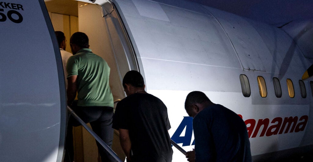 Colombian citizens board a chartered flight as they are deported from Panama City, Panama, to which they had illegally immigrated.