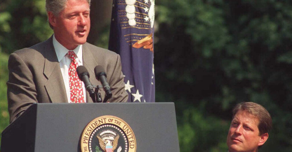 With then-Vice President Al Gore looking on, then- President Bill Clinton speaks to an audience in the White House Rose Garden.