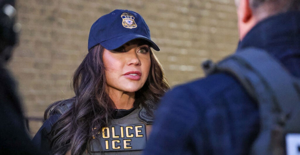 Department of Homeland Security Secretary Kristi Noem in a police/ICE vest and matching cap