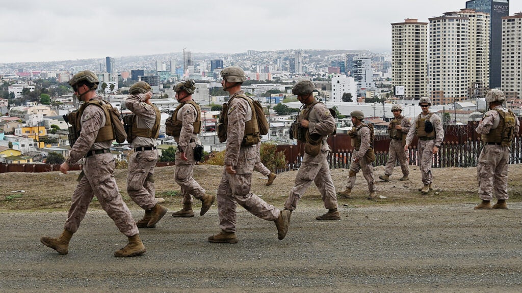 Border Patrol agents in military fatigues