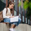 A female college student studying outdoors on campus
