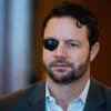 A mugshot of Rep. Dan Crenshaw, R-Texas, who has a patch over his right eye