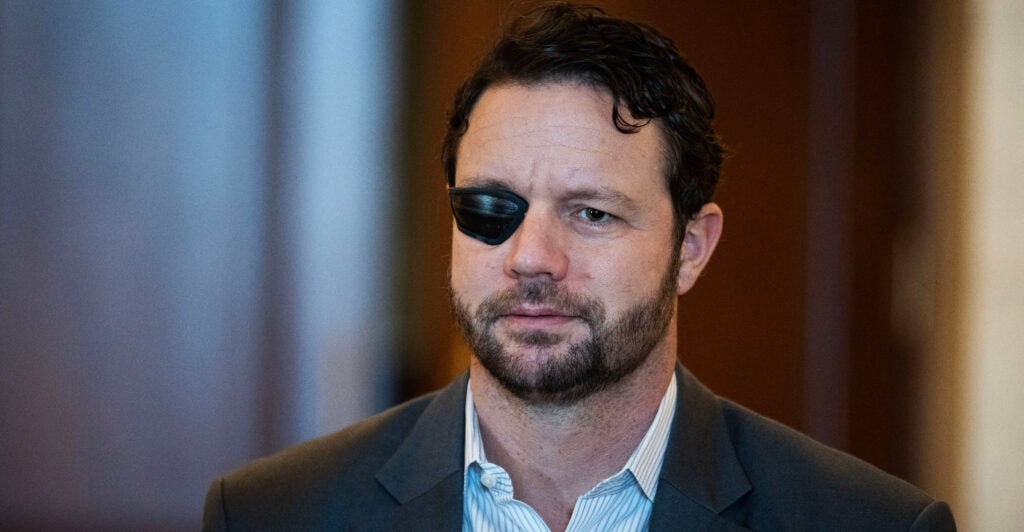 A mugshot of Rep. Dan Crenshaw, R-Texas, who has a patch over his right eye