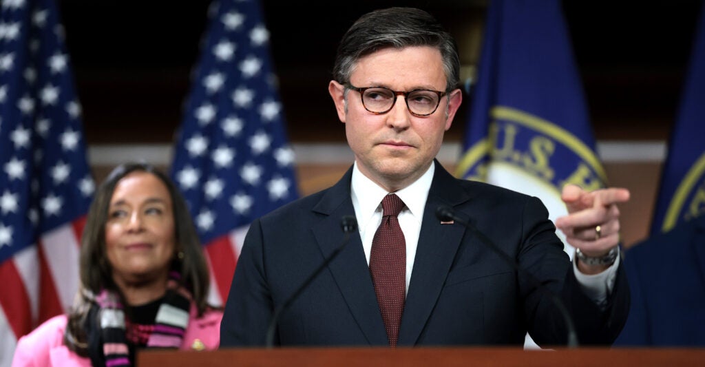 House Speaker Mike Johnson is flanked by Rep. Monica De La Cruz, R-Texas, at a Wednesday press conference.