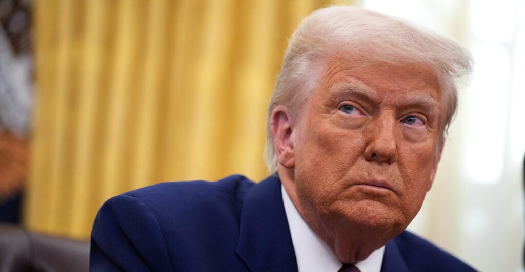 Donald Trump wears a navy suit.