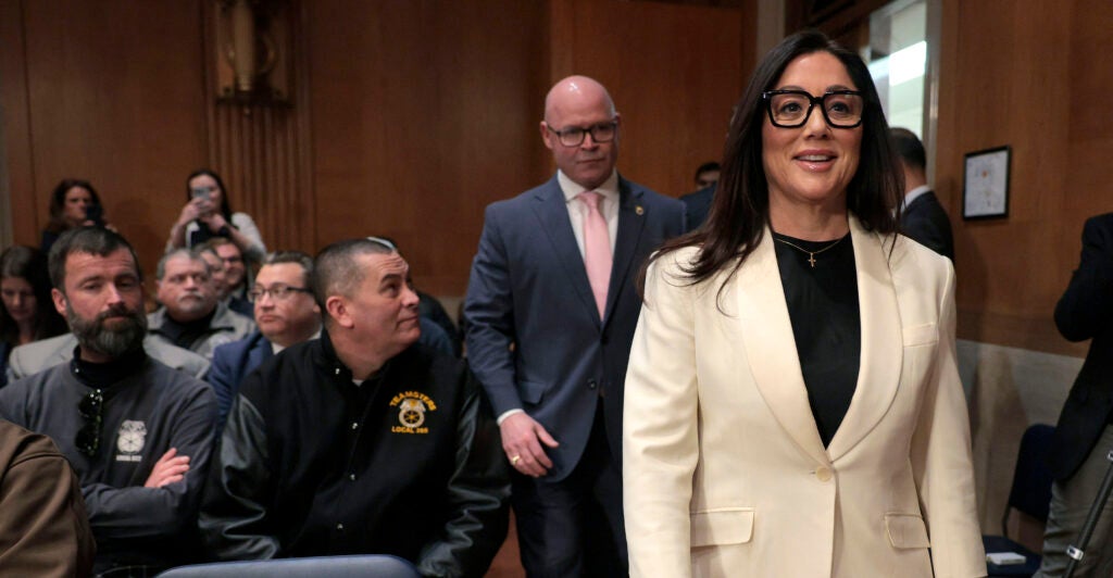 Lori Chavez-Deremer enters the Senate committee hearing room accompanied by Teamsters President Sean O'Brien.