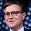 House Speaker Mike Johnson, R-La., with the stars of the U.S. flag behind him.
