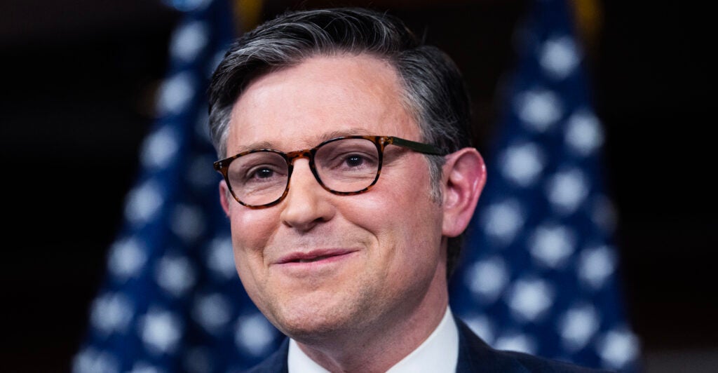 House Speaker Mike Johnson, R-La., with the stars of the U.S. flag behind him.