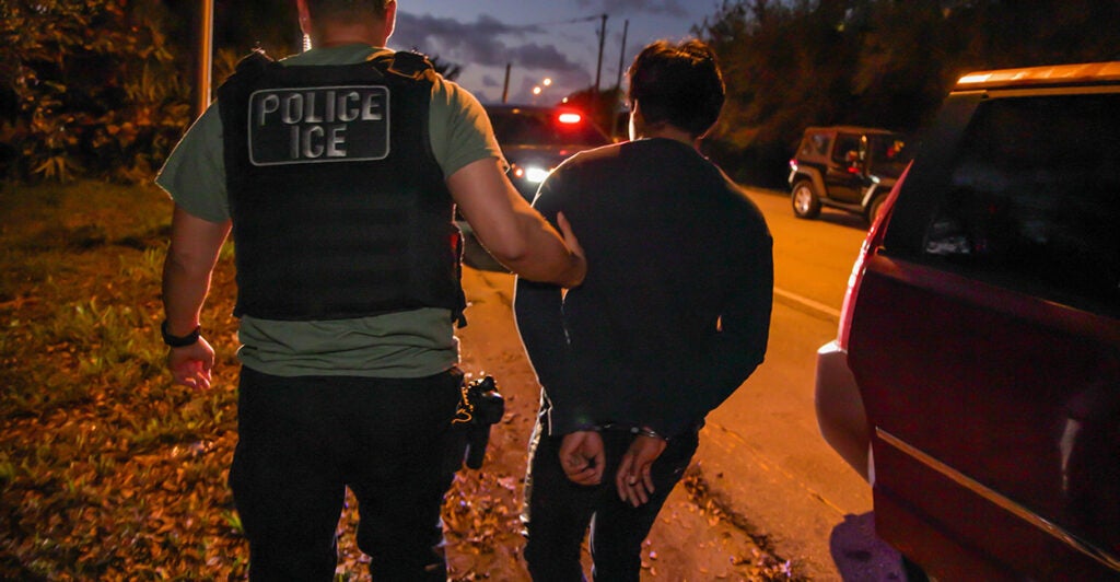 An ICE agent makes an arrest.