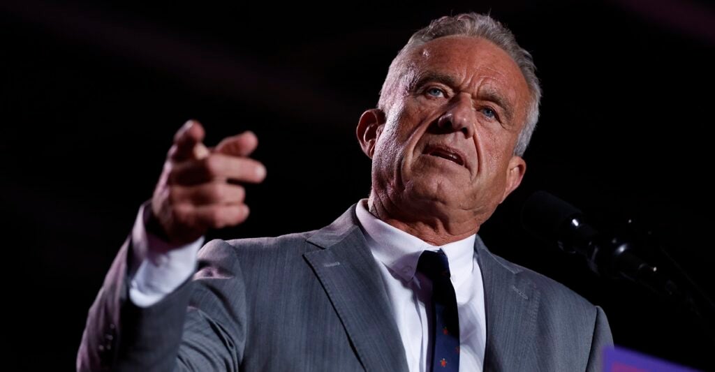 Robert F. Kennedy Jr., stands as he talks and points his right hand.