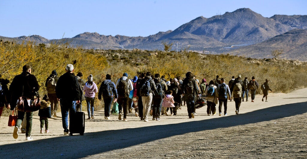 A group of illegal Immigrants travel through Jacumba Hot Springs, Calif., after crossing the border on Dec. 14, 2023.