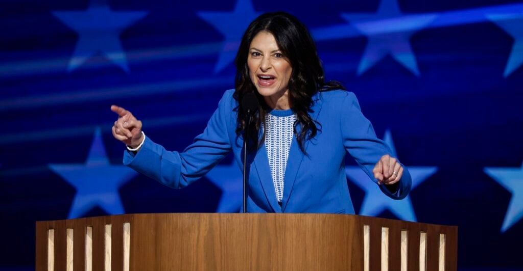 Dana Nessel is giving a speech and pointing her finger in an animated gesture.