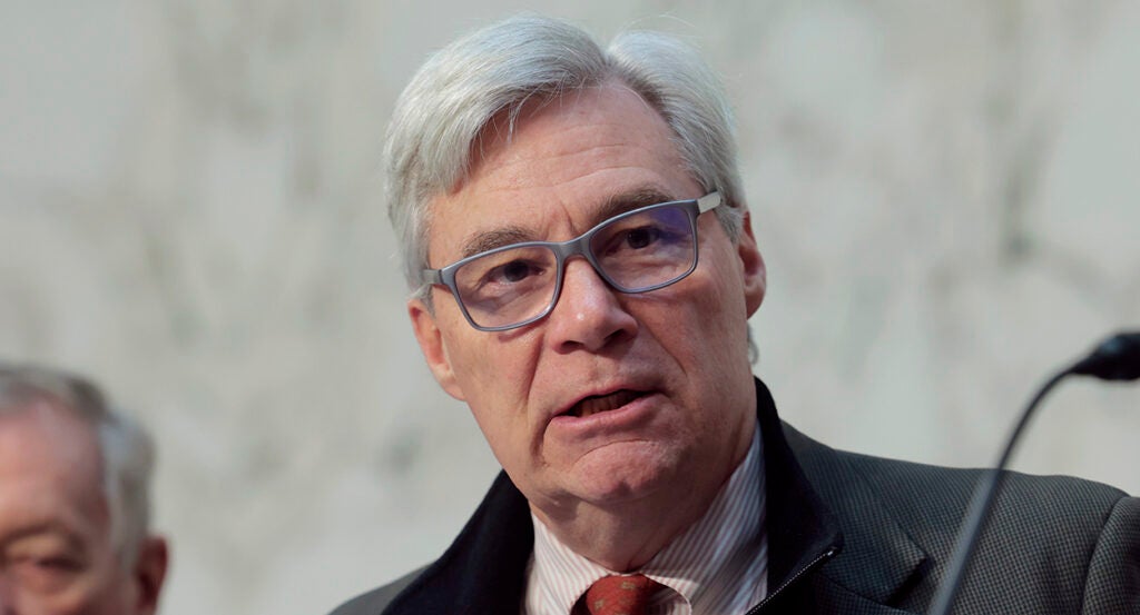 Sheldon Whitehouse in a suit and glasses