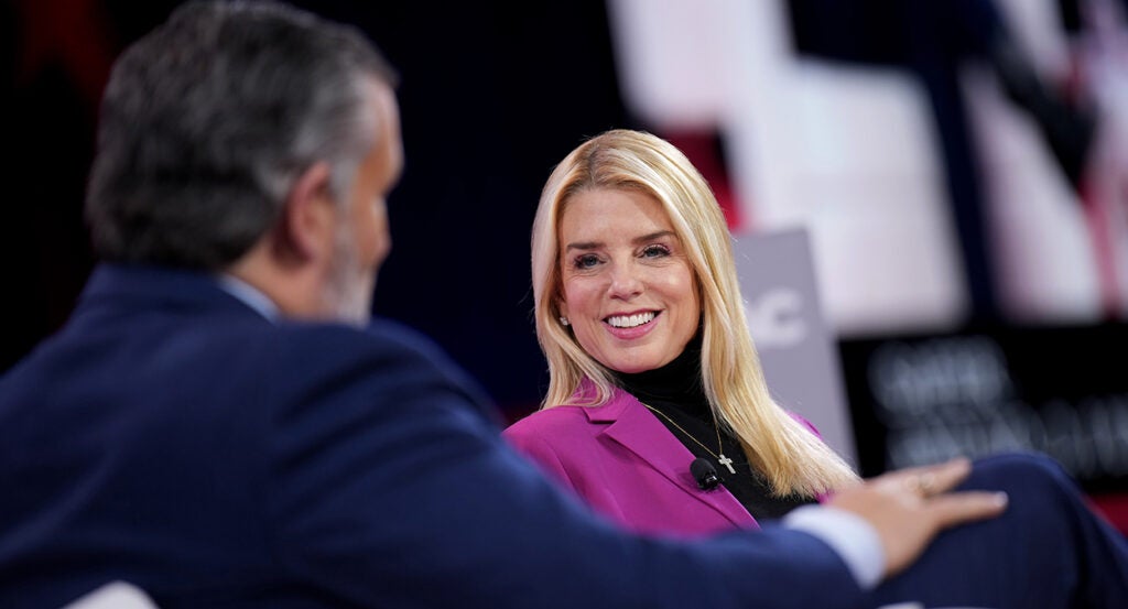 Pam Bondi smiles at Ted Cruz