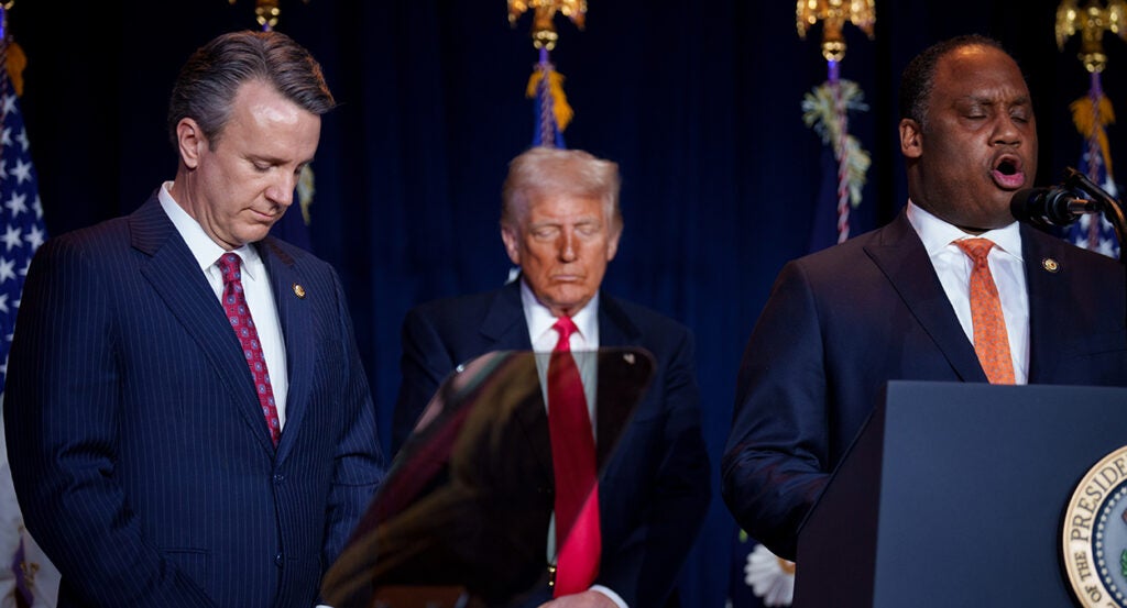 Donald Trump prays between Reps. Ben Cline and Jonathan Jackson
