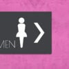 A restroom door with an outline logo of a woman