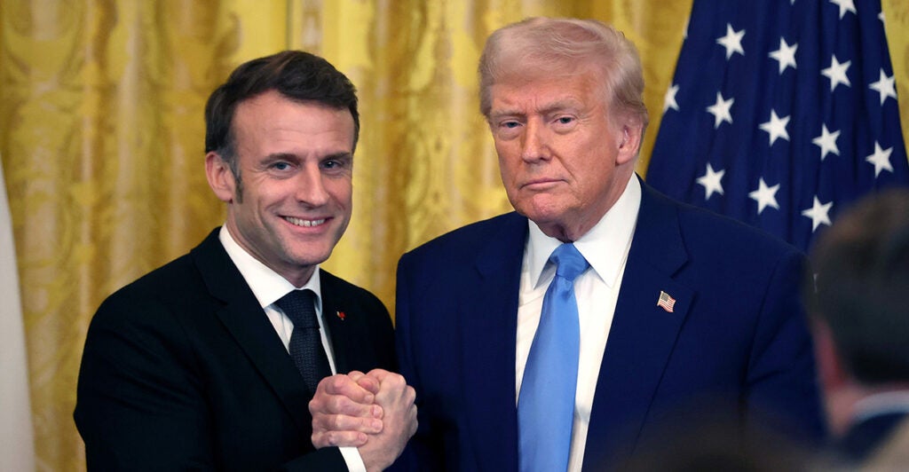 President Donald Trump and French President Emmanuel Macron shakes hands.