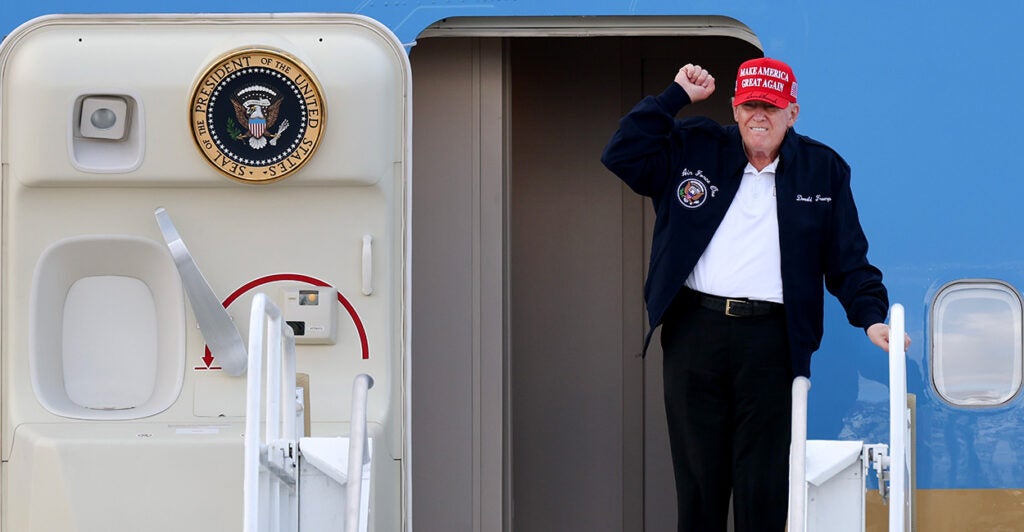 President Donald Trump gestures as he departs Air Force One.