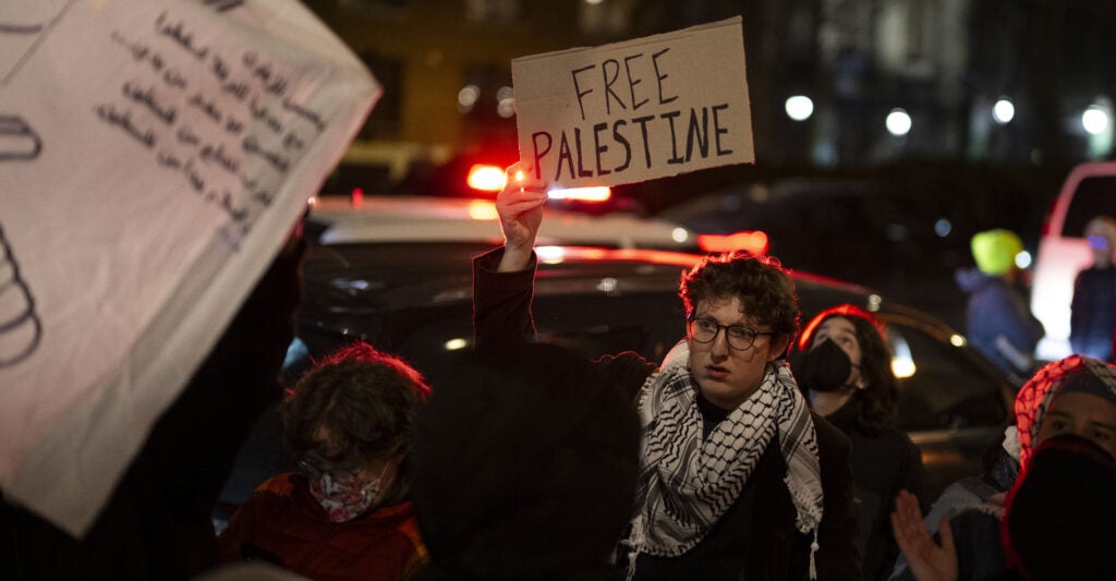 A protester holds a sign reading, "Free Palestine"