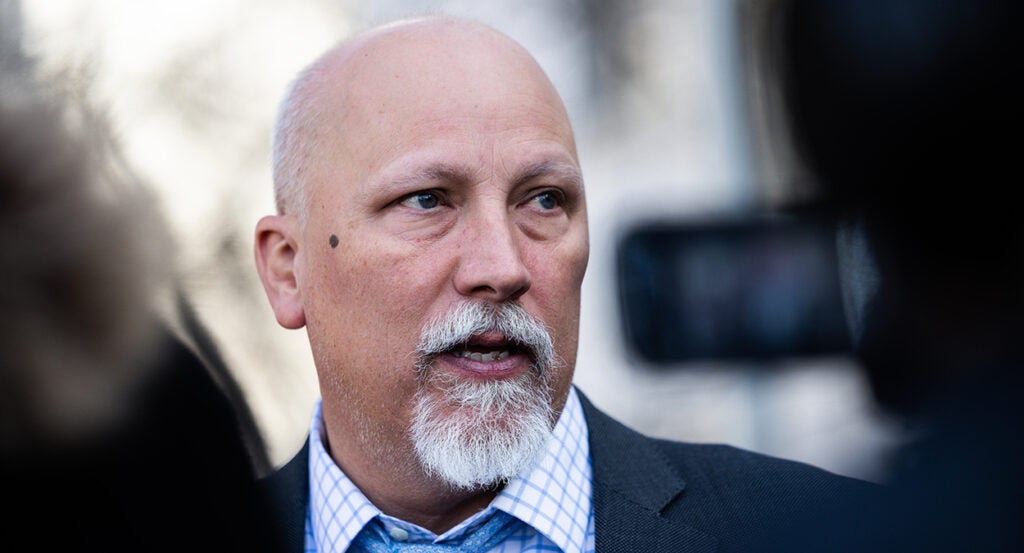 Chip Roy in a grey suit with a blue-checkered shirt