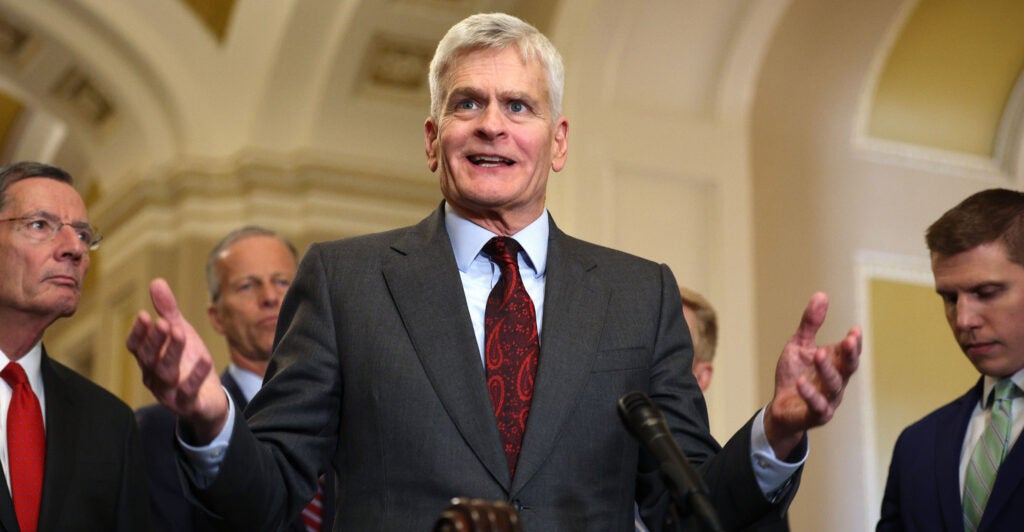 Sen. Bill Cassidy in a grey suit with a red tie