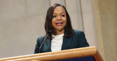 Kristen Clarke in a white shirt and a black dress jacket