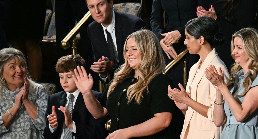 Payton McNabb in a black dress waves