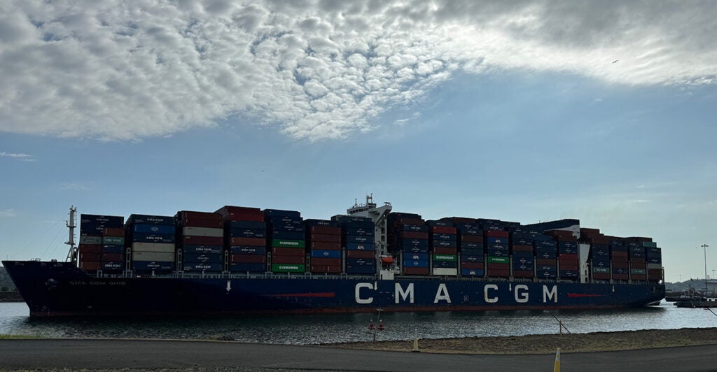 A large cargo ship moves through the Panama Canal.